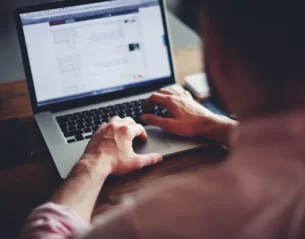 depositphotos_69202465-stock-photo-man-working-on-his-laptop